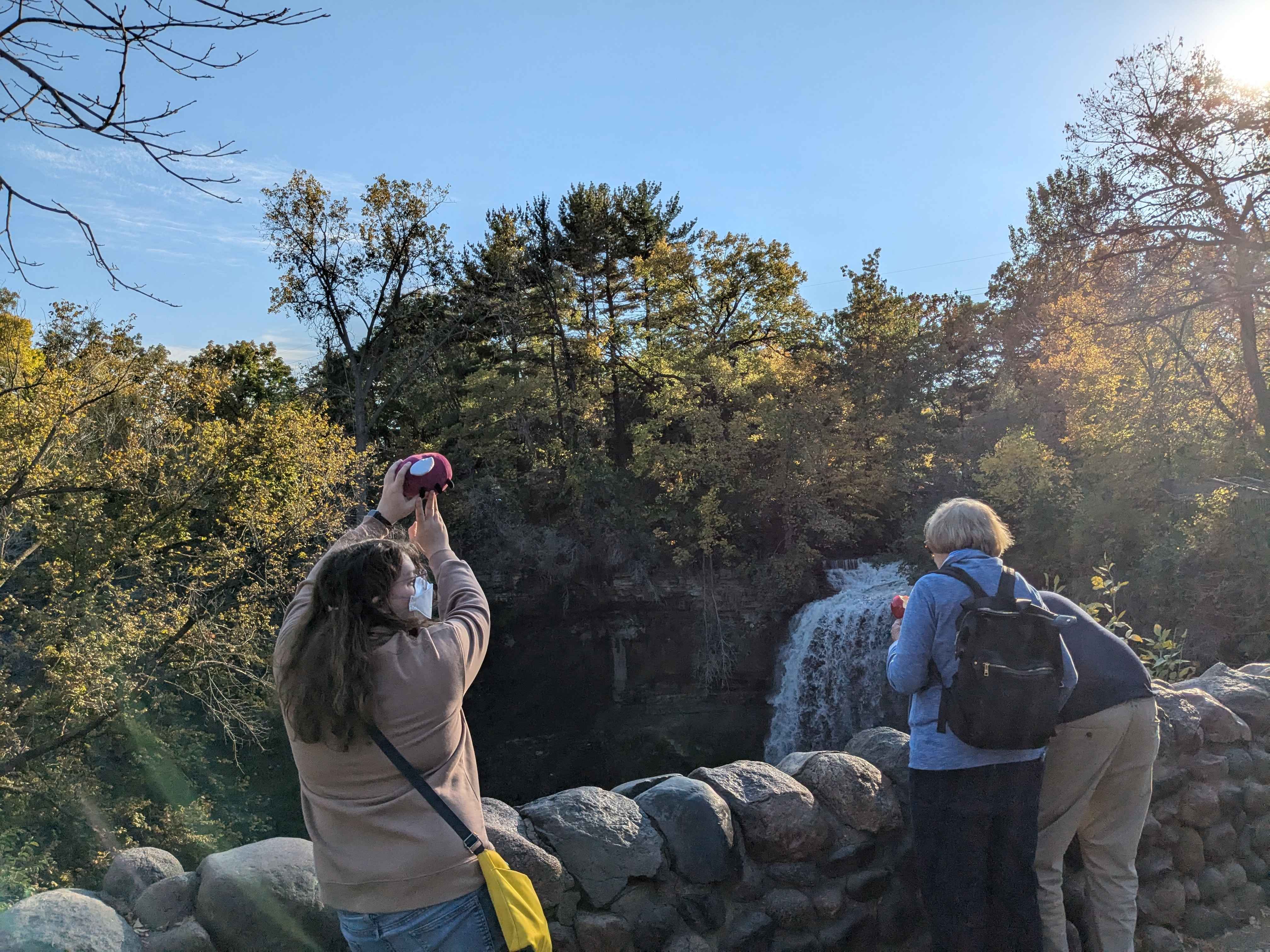 Me holding Eggbug in front of the falls.