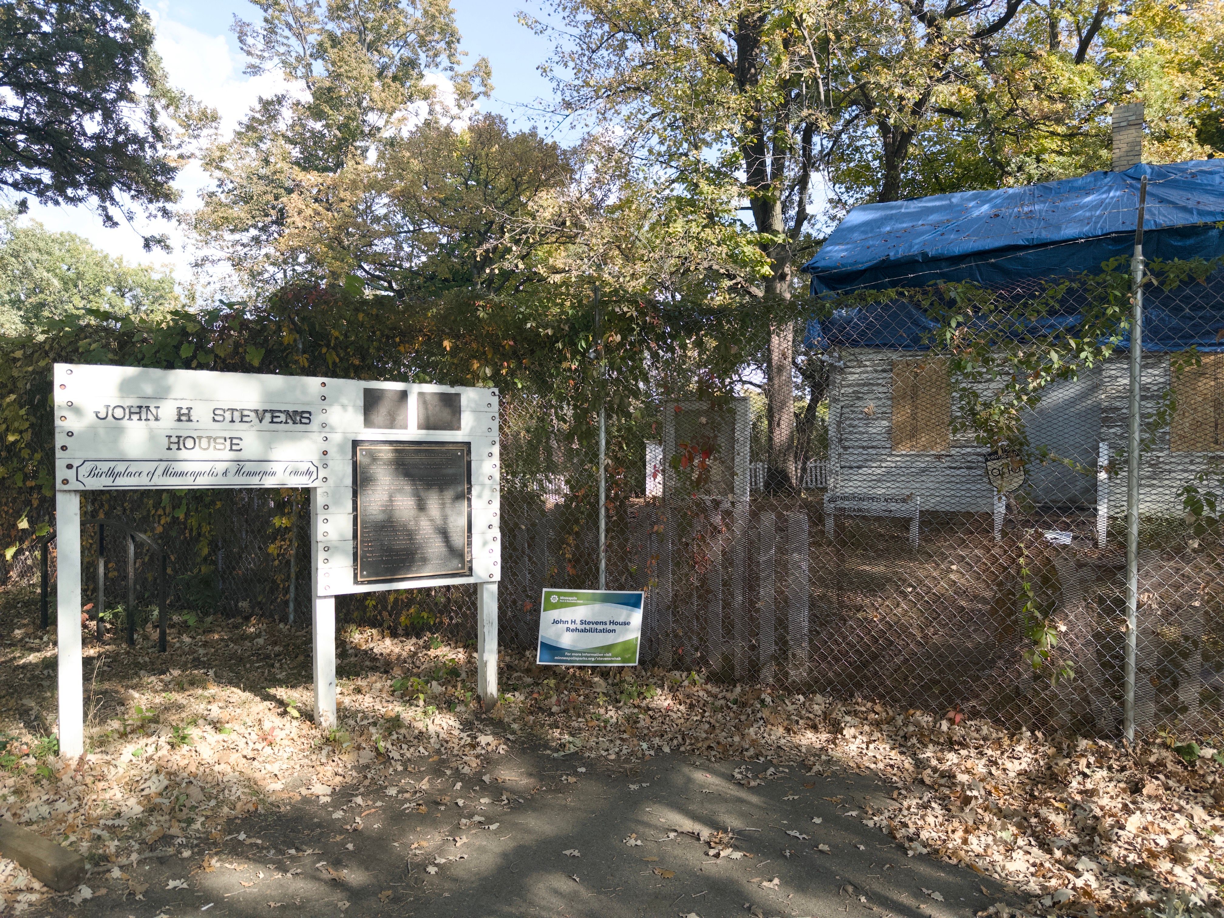 The house of John H. Stevens, and the birthplace of Minneapolis. It is a house covered in blue tarp and guarded by a chain-link fence. Doesn’t look particularly historic.